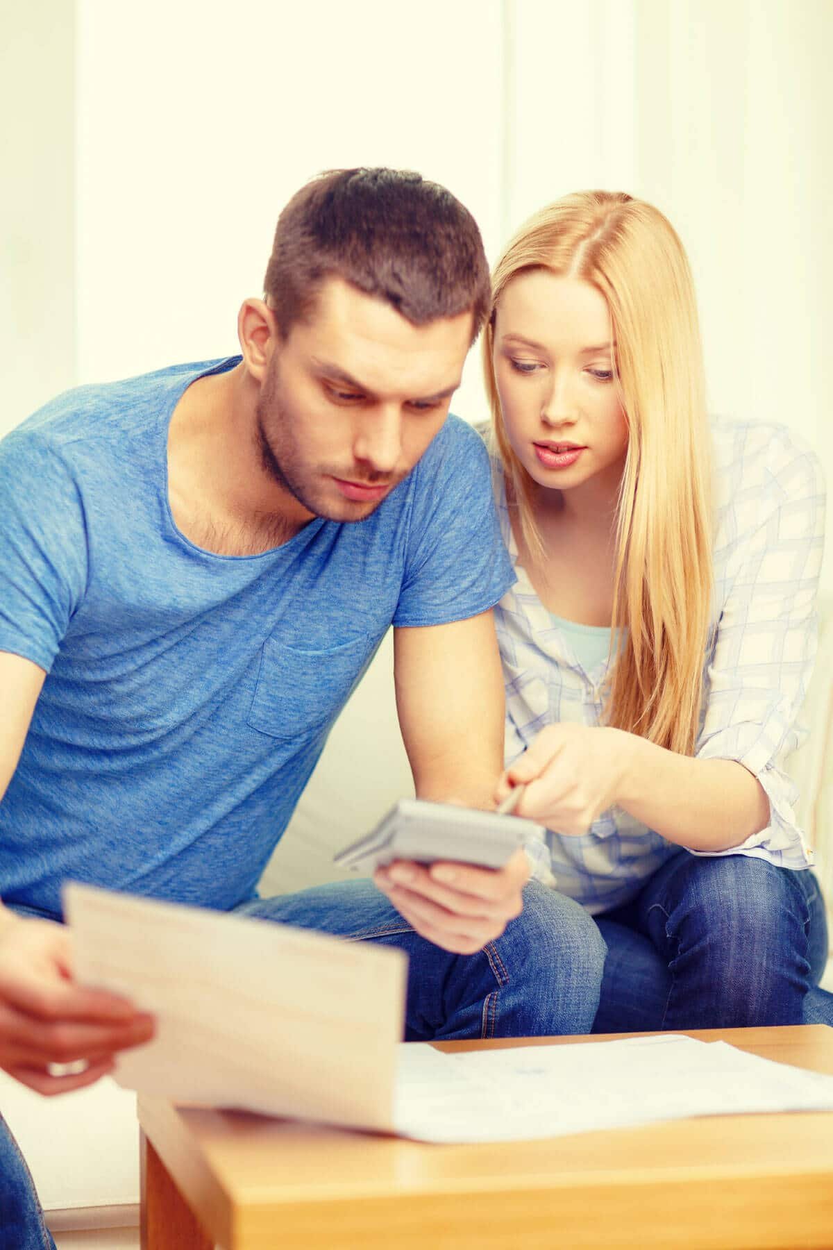 papers-and-calculator-at-home couple with papers and calculator at home