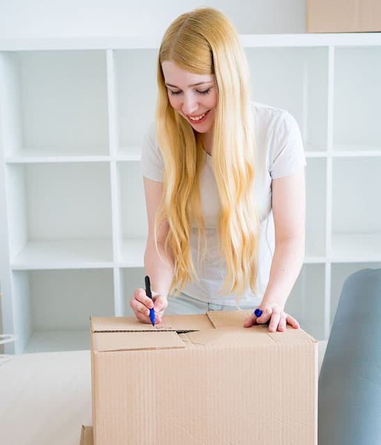 woman-writing-on-box-we-buy-houses middle-banner